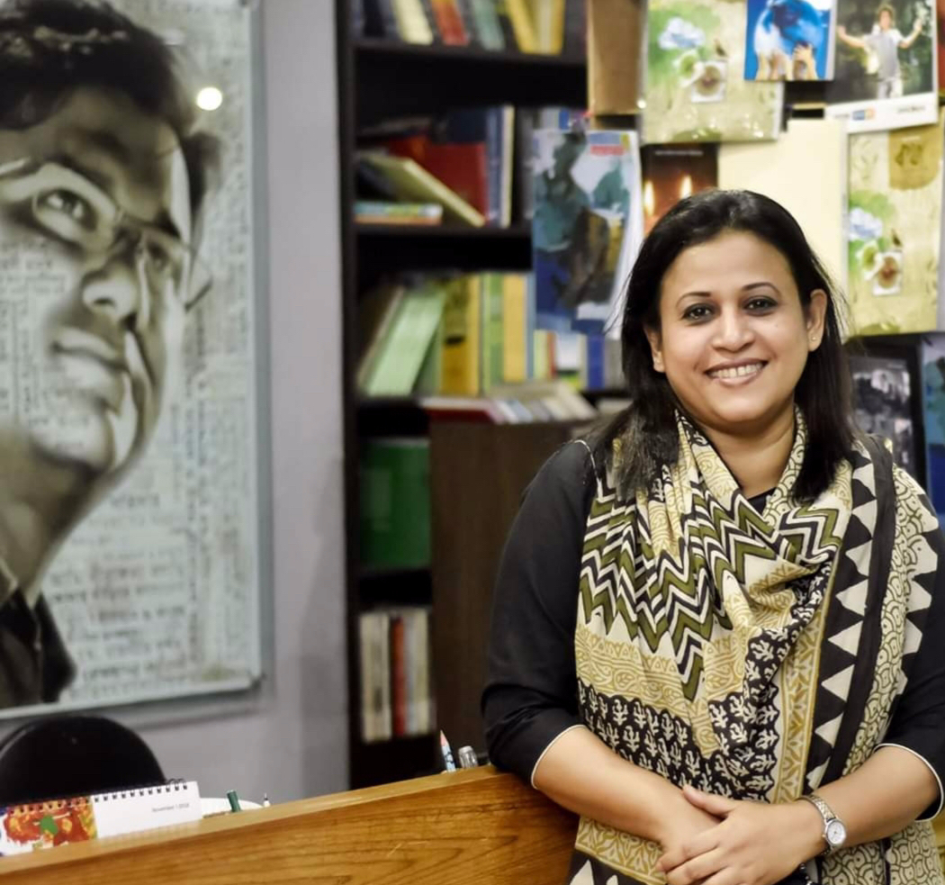 Razia Rahman Joly next to a picture of her husband Faisal Arefin Dipan